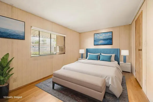 a bedroom with a bed and a potted plant