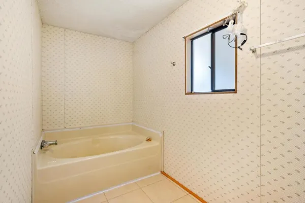 a white bath tub sitting next to a shower
