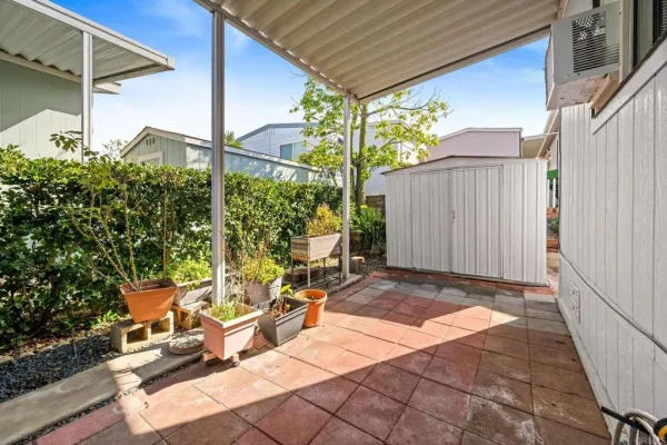 a view of a patio with table and chairs and potted plants