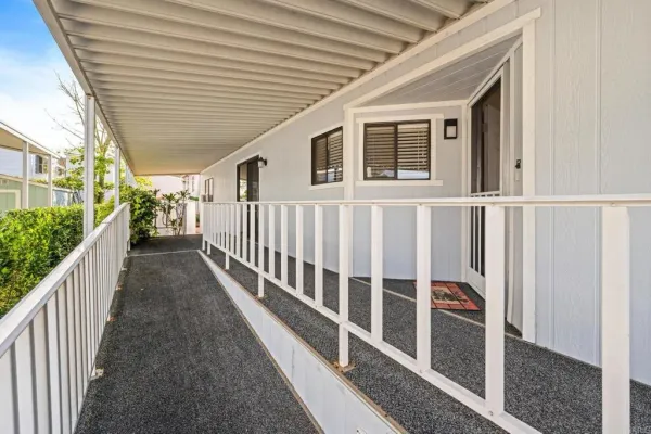 a view of a house with wooden deck