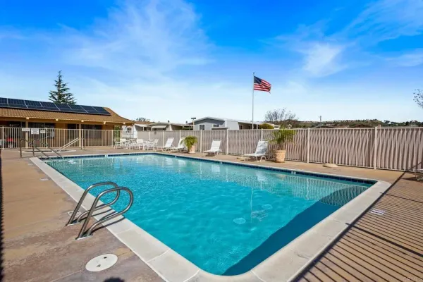 a view of a swimming pool with a chair and tables