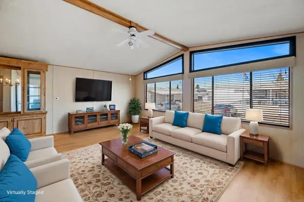 a living room with furniture a large window and a flat screen tv