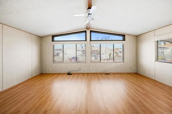 wooden floor in an empty room with a window