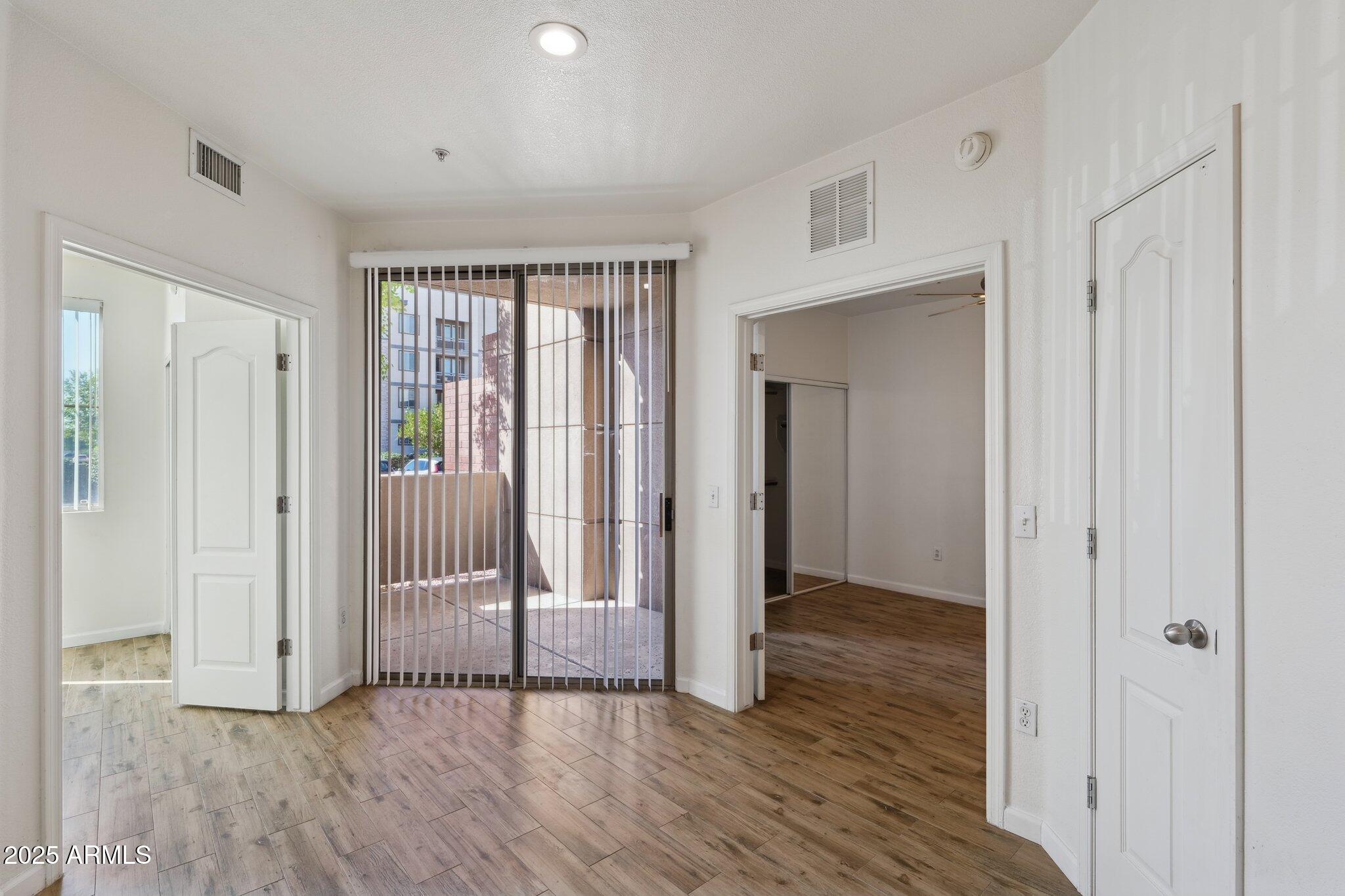1701 East Colter Street, Unit 182 Phoenix, AZ 85016 - Photo 12 of 55 a view of a hallway with wooden floor and brick walls