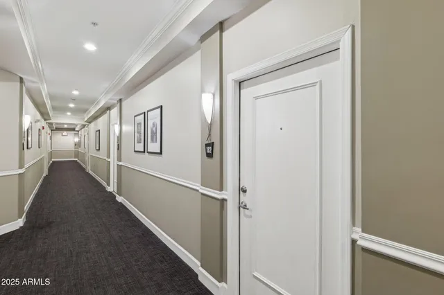 a view of a hallway with the glass door and stairs