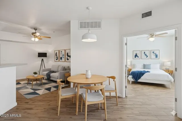 a living room with furniture and a wooden floor