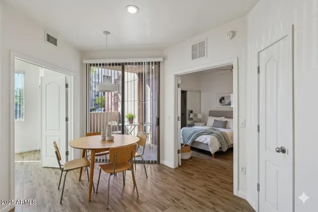 a dining room with furniture and wooden floor