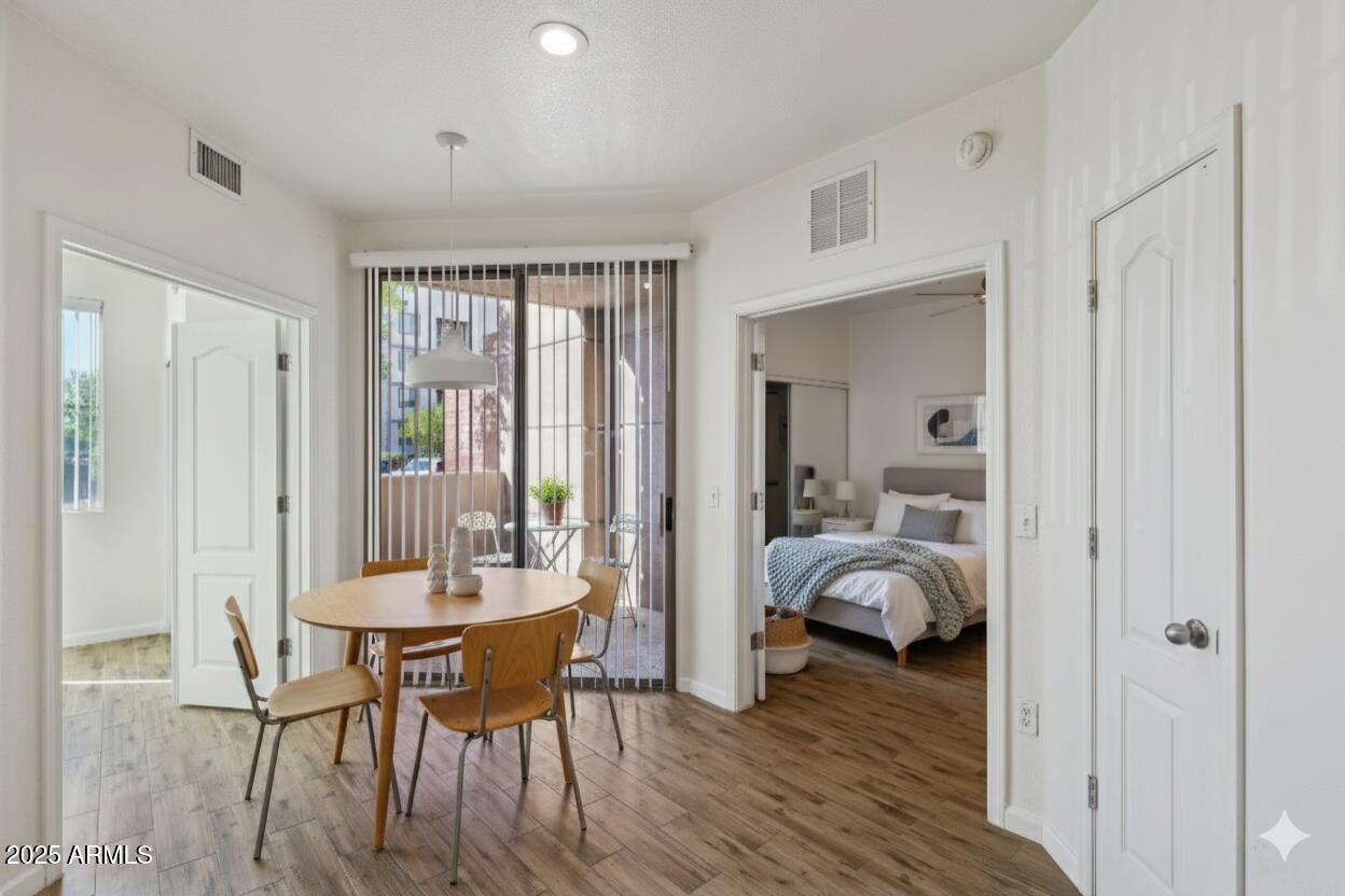 1701 East Colter Street, Unit 182 Phoenix, AZ 85016 - Photo 3 of 55 a dining room with furniture and wooden floor