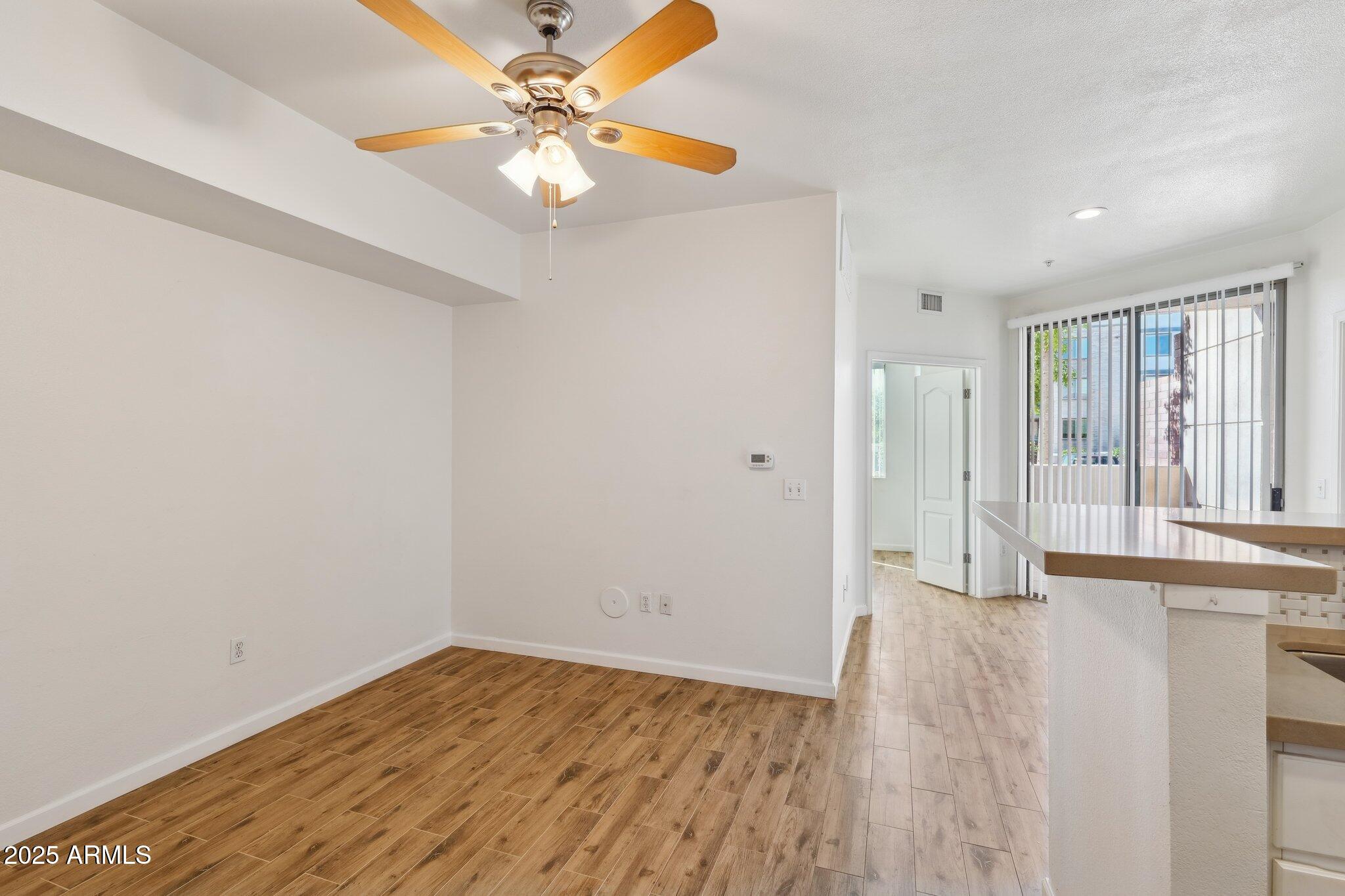 1701 East Colter Street, Unit 182 Phoenix, AZ 85016 - Photo 5 of 55 wooden floor in an empty room with a window