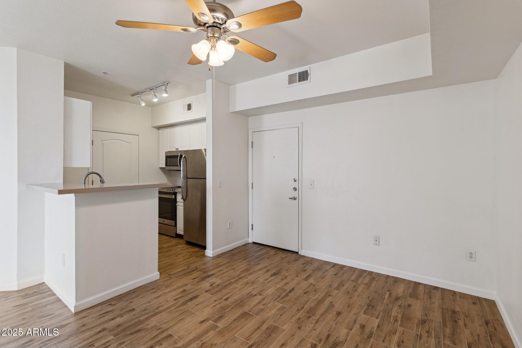 1701 East Colter Street, Unit 182 Phoenix, AZ 85016 - Photo 6 of 55 a view of a kitchen with a sink and a refrigerator