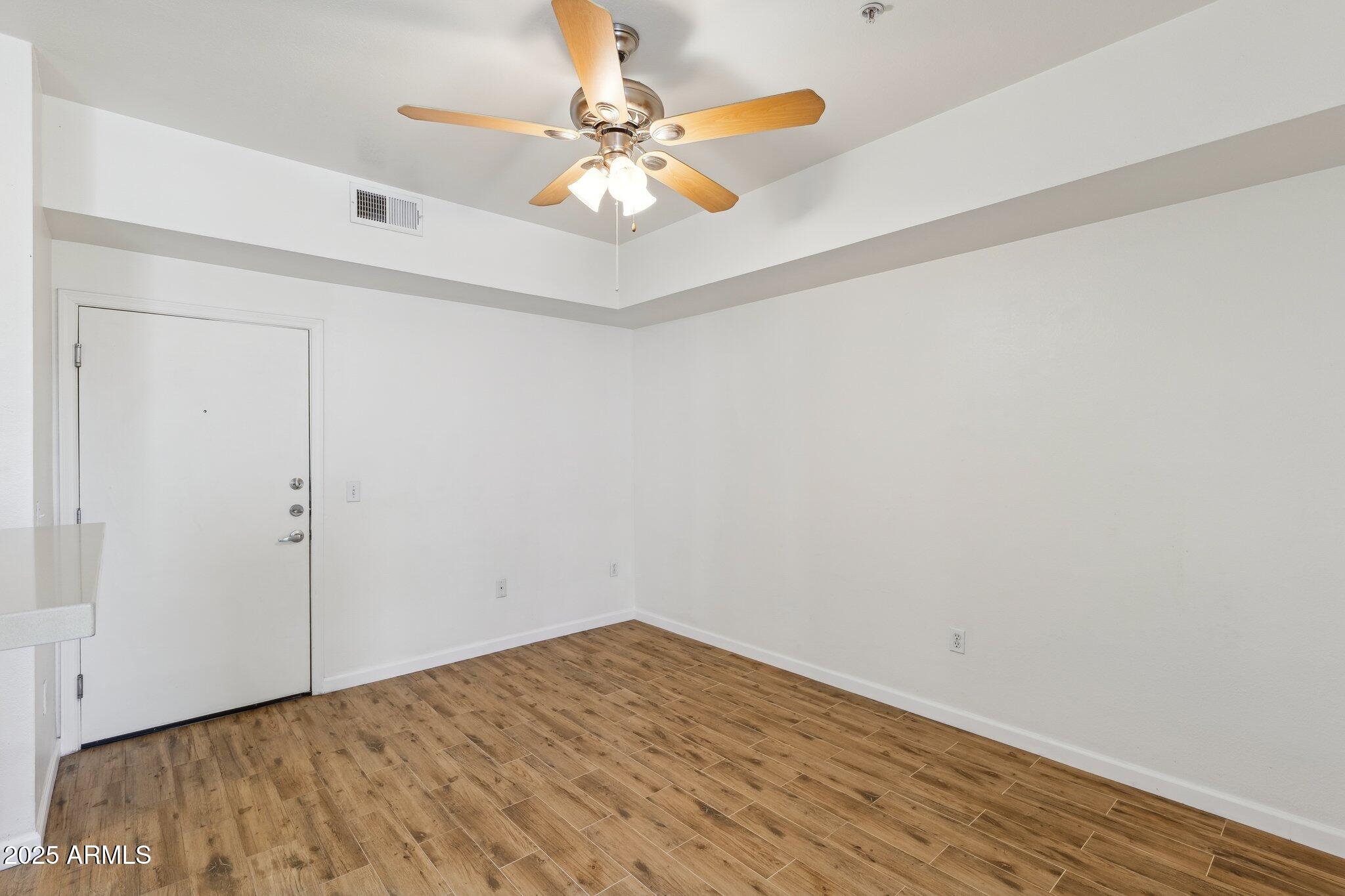 1701 East Colter Street, Unit 182 Phoenix, AZ 85016 - Photo 7 of 55 a view of a room with wooden floor and a ceiling fan