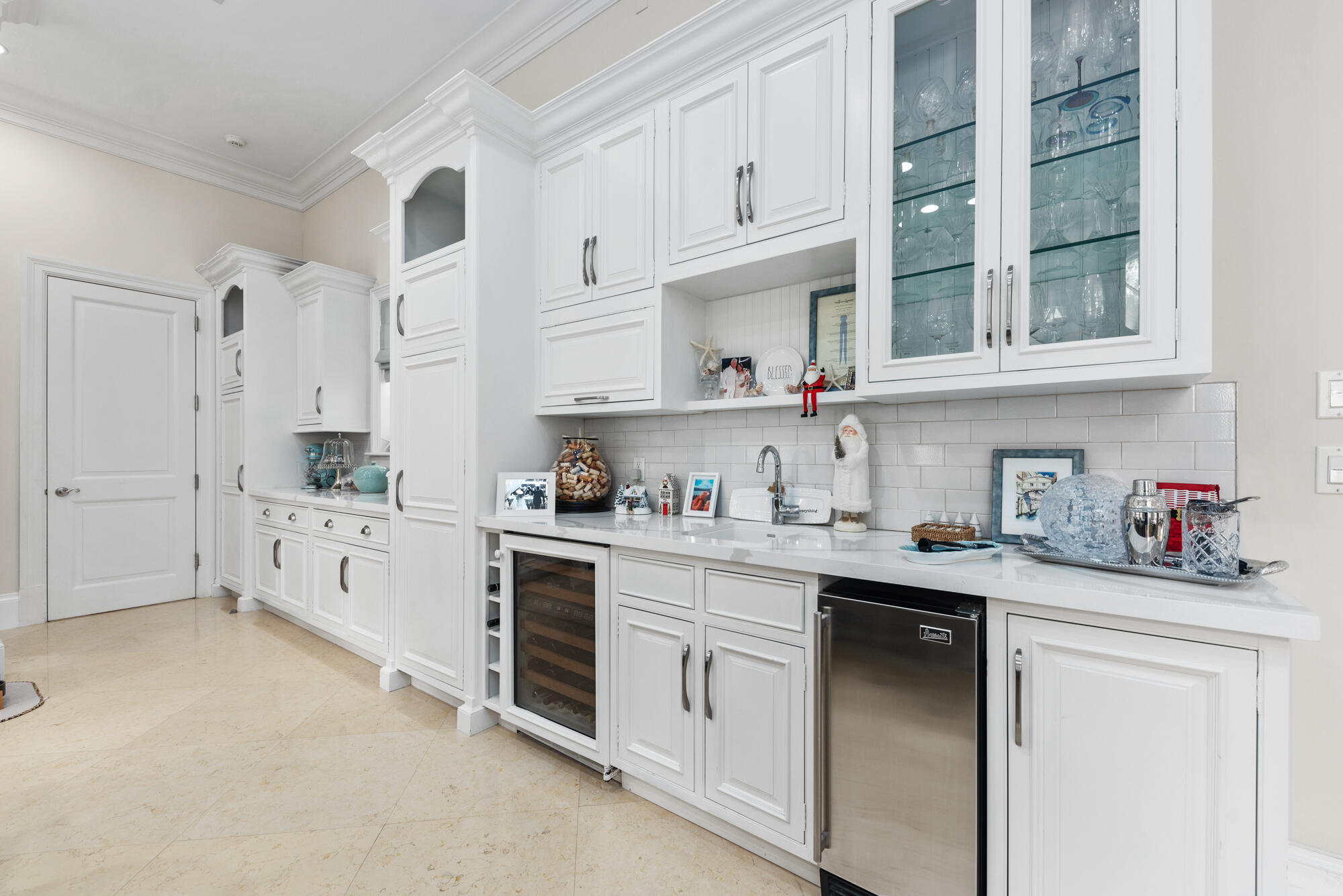 503 Bald Eagle Drive Jupiter, FL 33477 - Photo 11 of 62 a kitchen with stainless steel appliances granite countertop a sink and cabinets with wooden floor