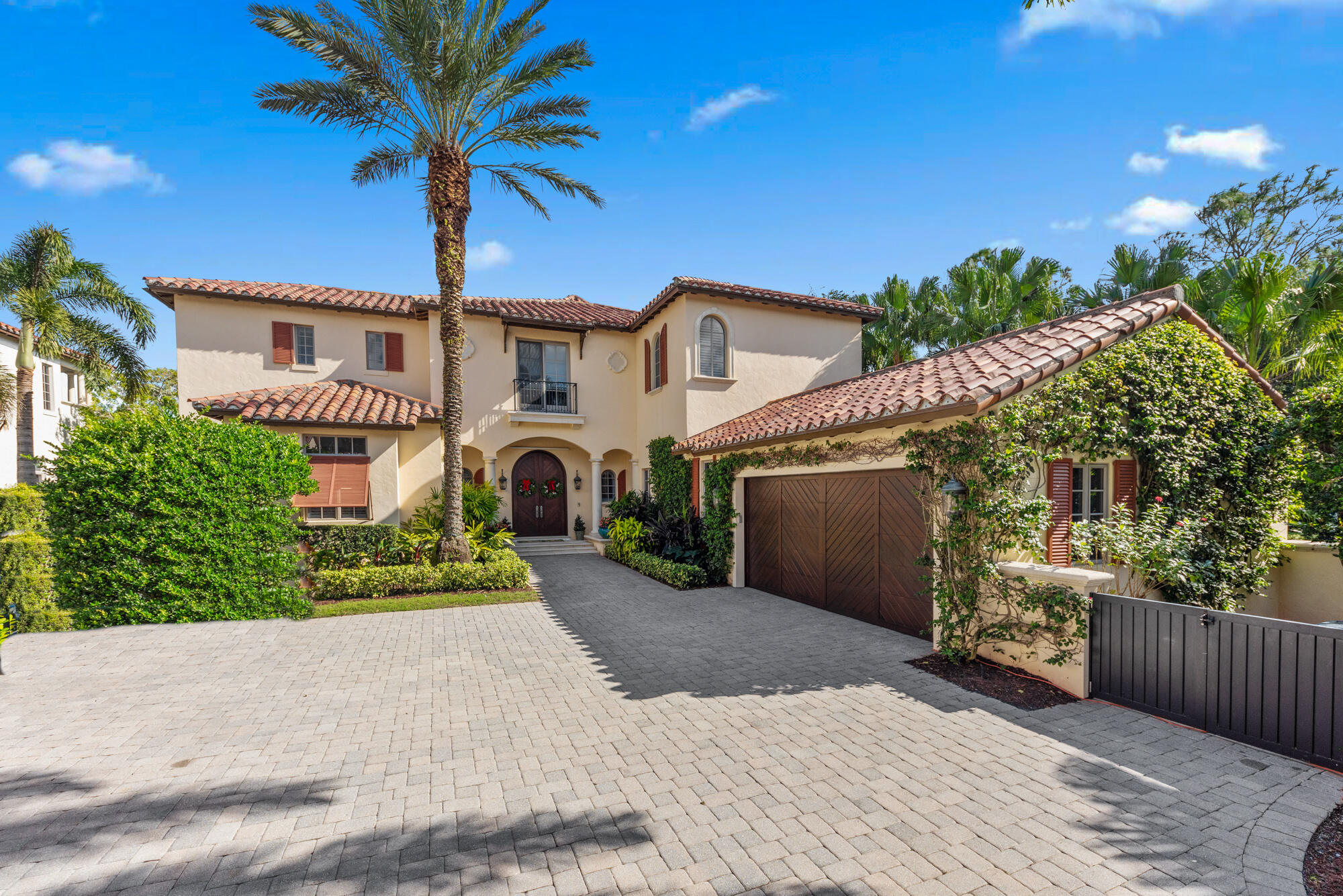 503 Bald Eagle Drive Jupiter, FL 33477 - Photo 2 of 62 a front view of a house with a yard and garage