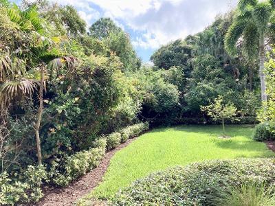 503 Bald Eagle Drive Jupiter, FL 33477 - Photo 37 of 62 a view of a garden with a bench
