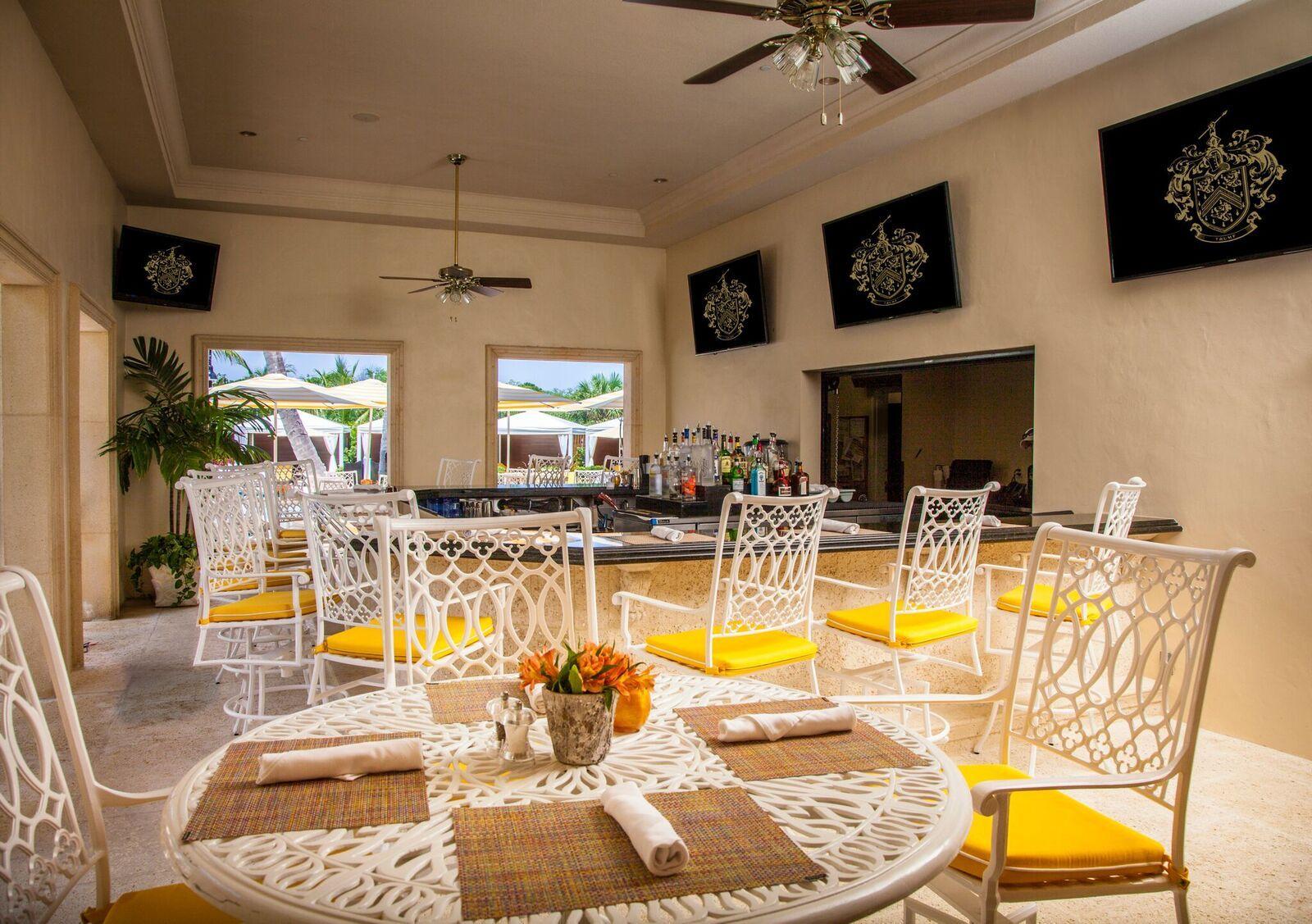 503 Bald Eagle Drive Jupiter, FL 33477 - Photo 43 of 62 a view of a dining room with furniture a fireplace and a flat screen tv