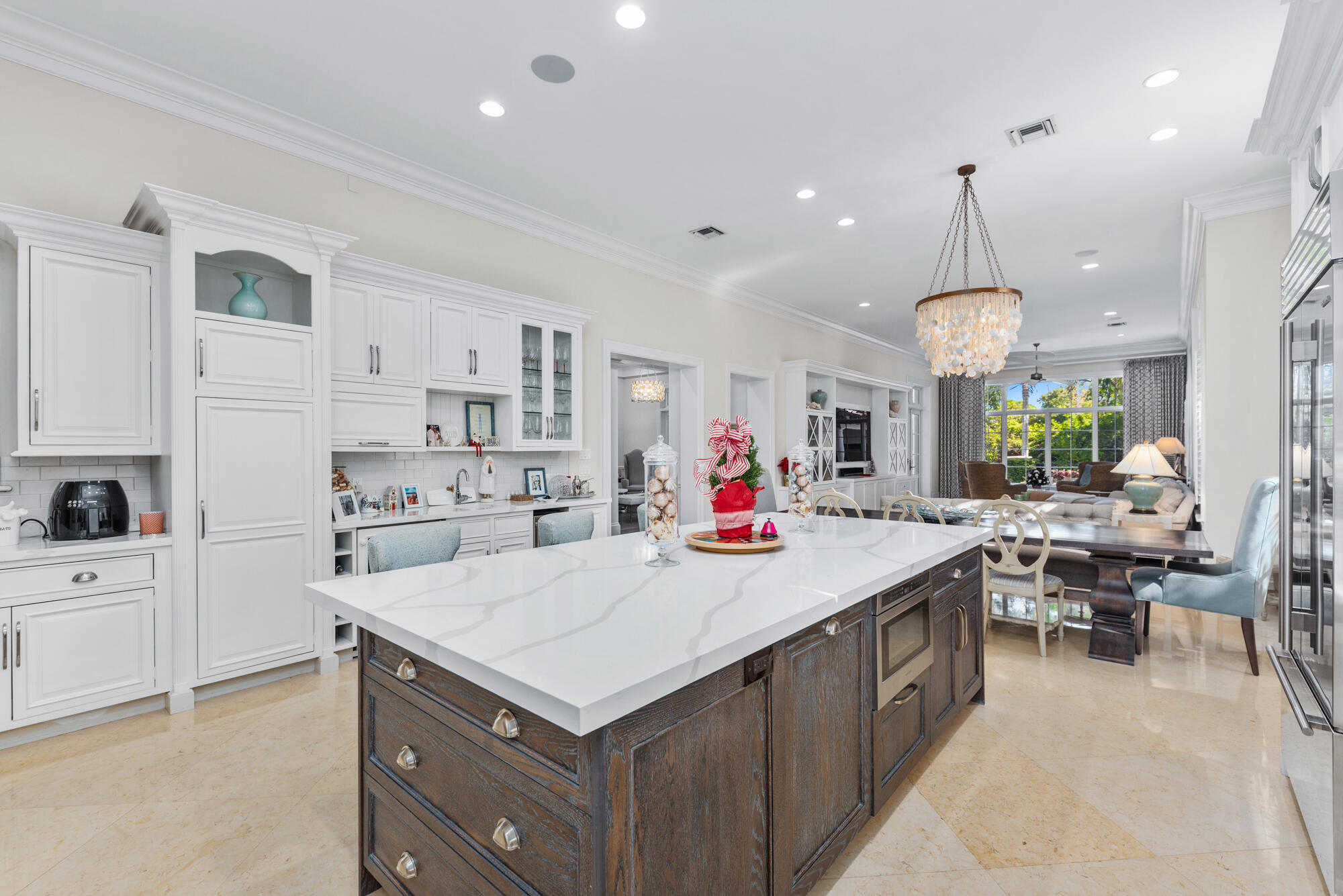 503 Bald Eagle Drive Jupiter, FL 33477 - Photo 8 of 62 a kitchen with a stove a refrigerator and a living room