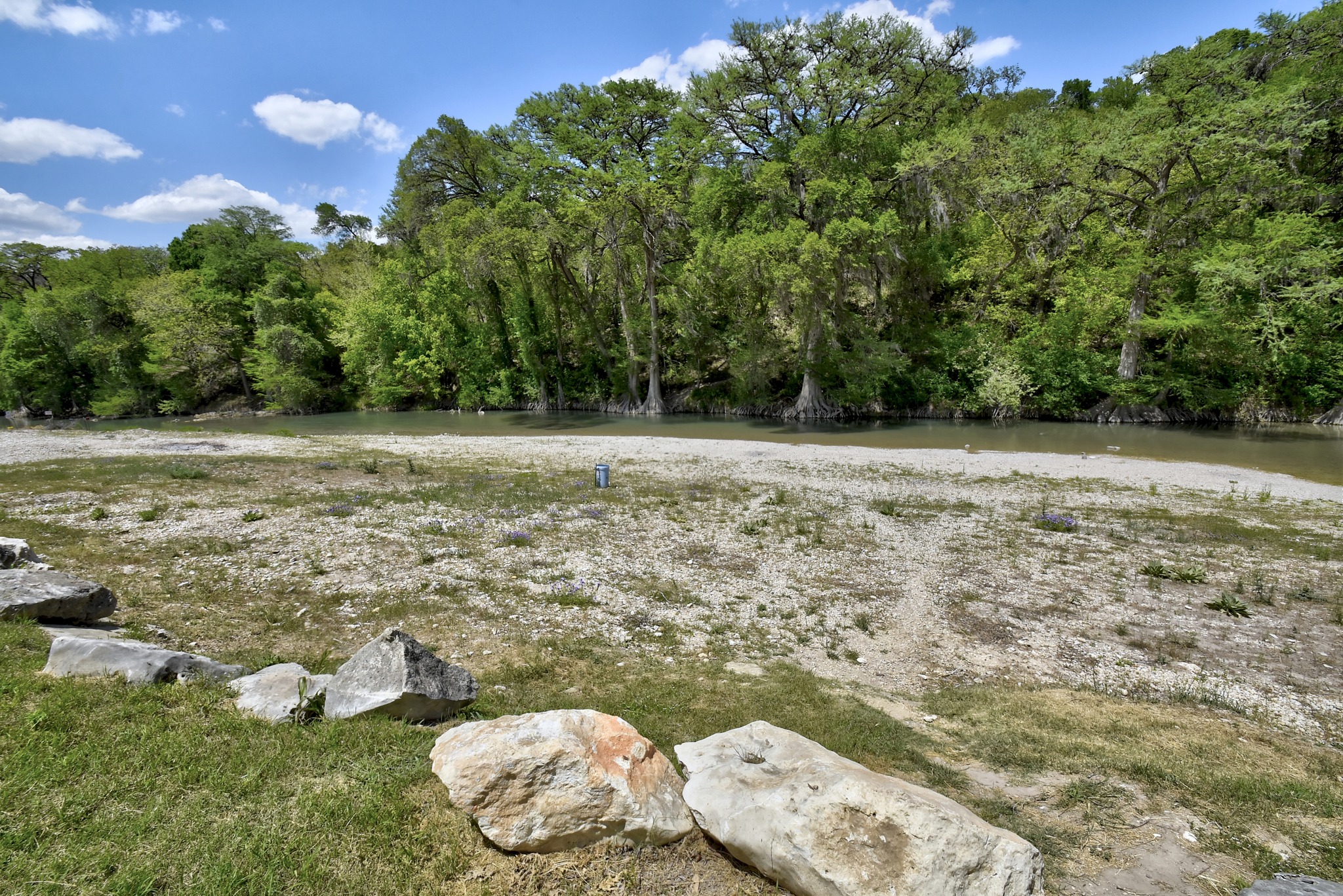 1170 Misty Lane Spring Branch, TX 78070 - Photo 11 of 24 A tranquil riverfront lot, bordered by verdant trees, invites outdoor enjoyment.