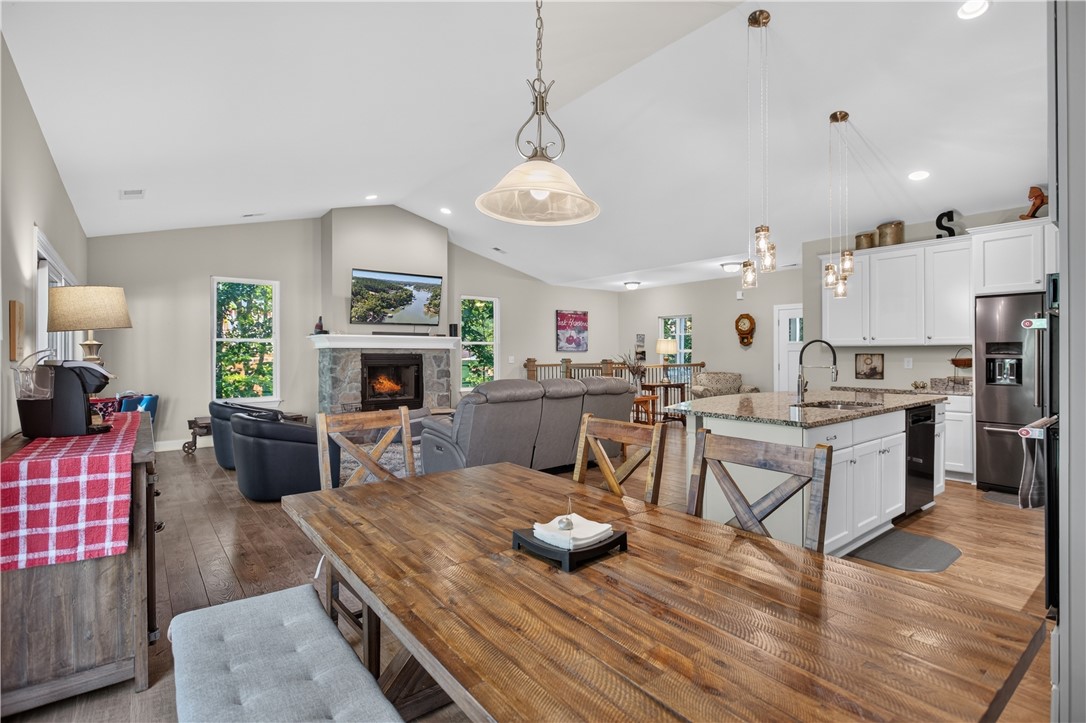 321 High Hampton Road Salem, SC 29676 - Photo 9 of 46 Vaulted ceilings soar over a stone-accented fireplace in this open-concept main level.