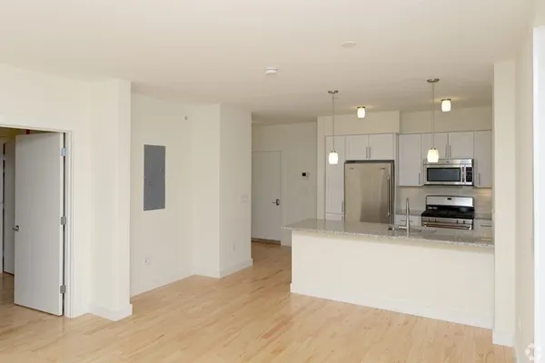 a kitchen with stainless steel appliances a refrigerator and a stove top oven