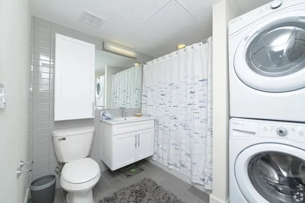 a bathroom with a sink a toilet and a mirror