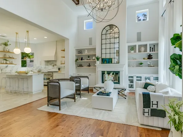 a living room with furniture a rug and a chandelier