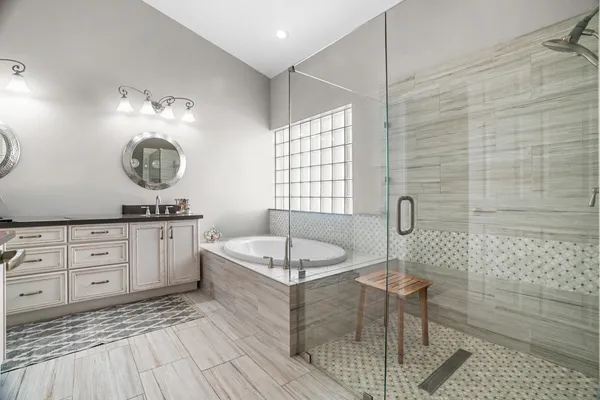 a bathroom with a granite countertop sink a toilet and mirror