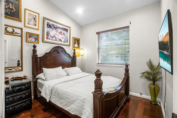 a bedroom with a bed and a flat screen tv