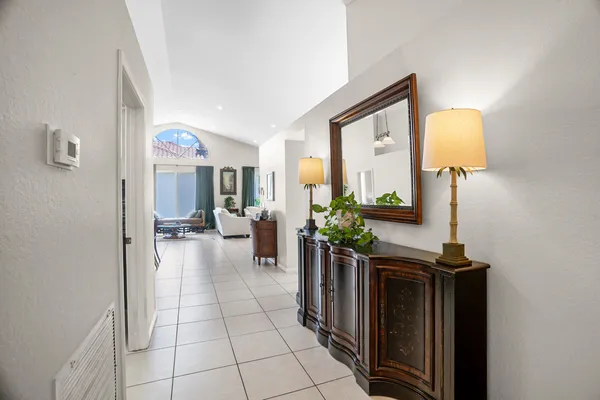 a hallway with a dining table and a mirror