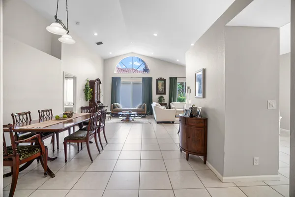a view of a dining room with furniture and a chandelier