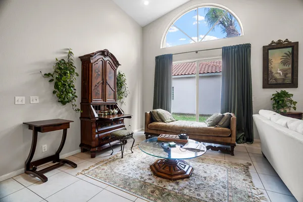 a living room with furniture and a potted plant