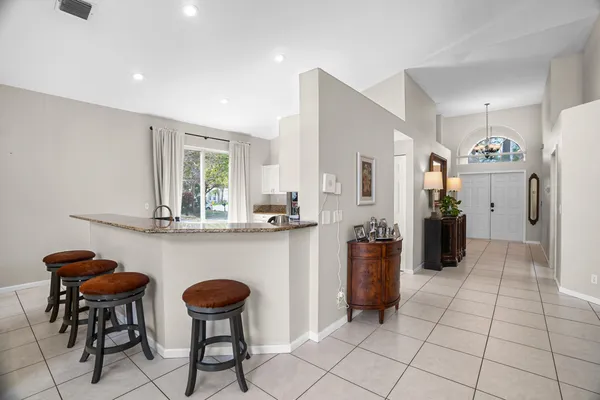 a kitchen with stainless steel appliances granite countertop a refrigerator and a stove top oven