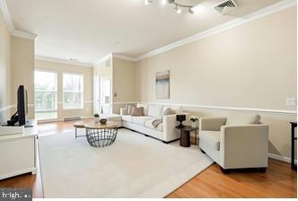 8045 Newell Street, Unit 423 Silver Spring, MD 20910 - Photo 9 of 26 a living room with furniture and a large window