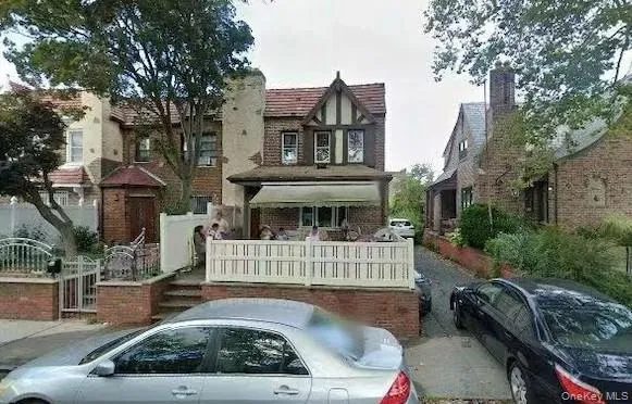 a view of a house with a small yard and furniture