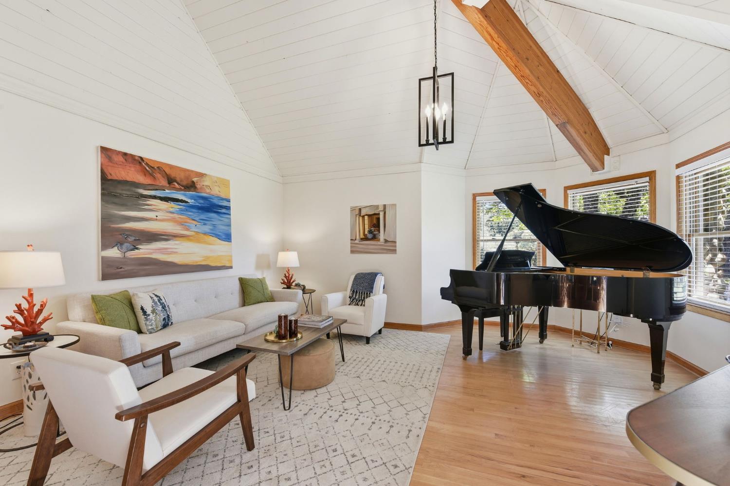 7201 Happy Valley Road Somerset, CA 95684 - Photo 20 of 75 The living room is to the right of the foyer and haas room for this Parlor grand piano the wood flooring is a lightly stained natural wood that adds to the natural light and haas a soft touch to the feet.