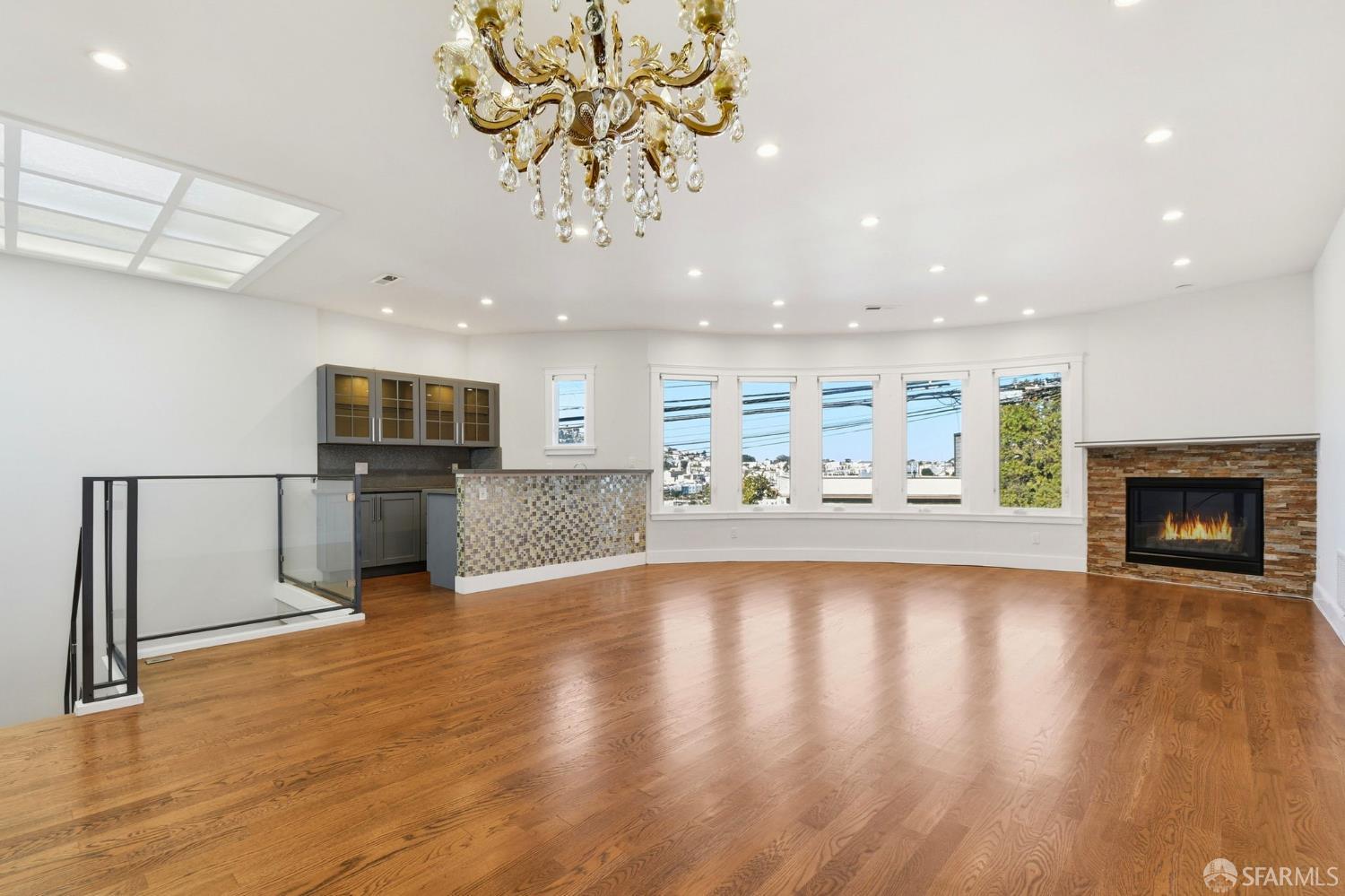 526 Silver Avenue San Francisco, CA 94112 - Photo 17 of 44 a view of a kitchen with a sink wooden floor and a fireplace