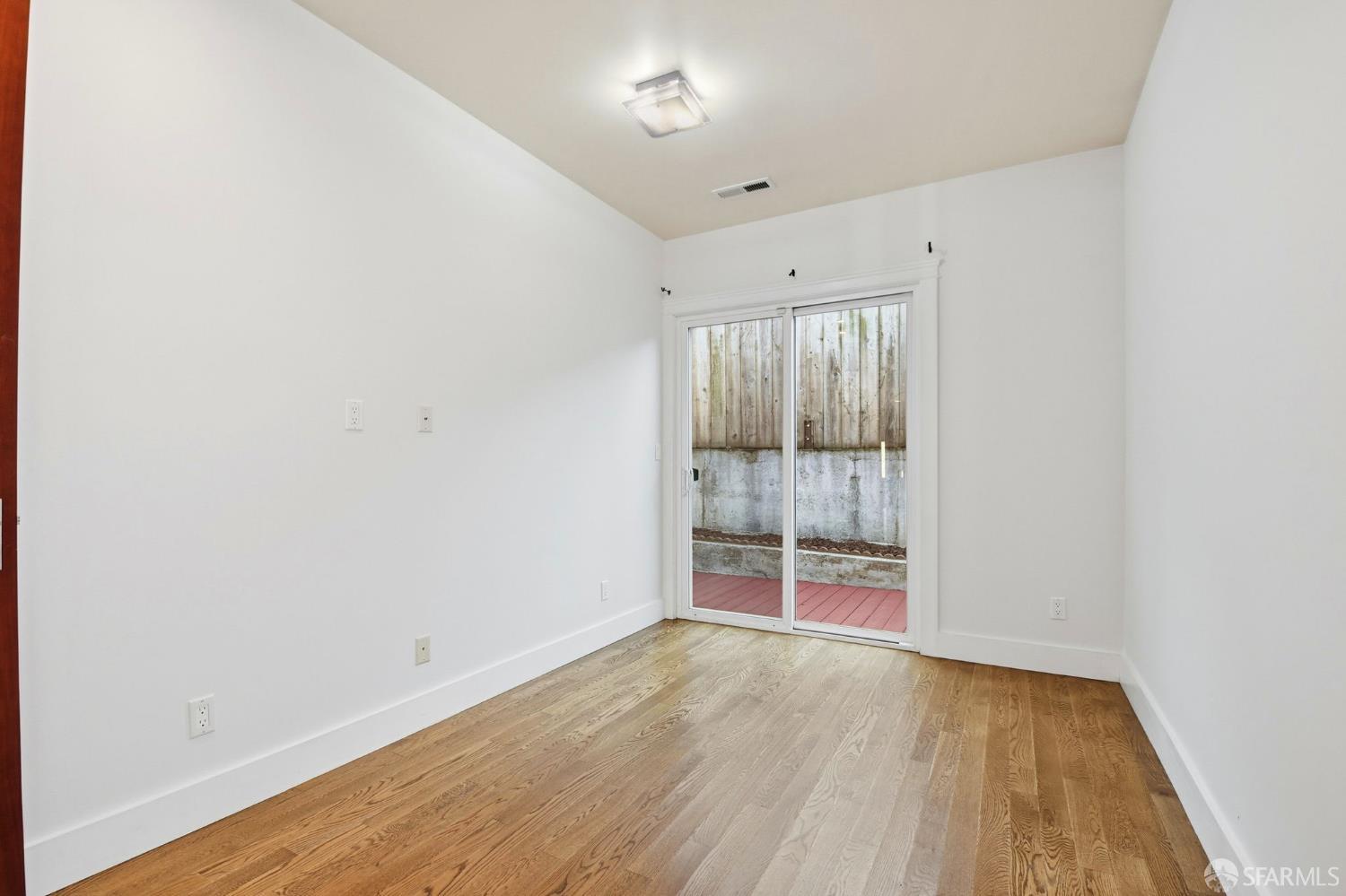 526 Silver Avenue San Francisco, CA 94112 - Photo 18 of 44 an empty room with wooden floor and door
