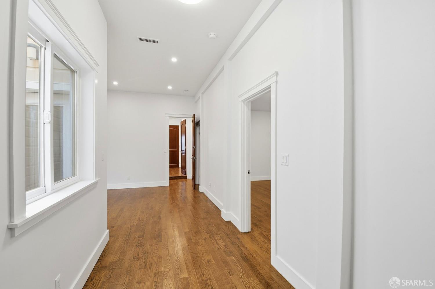 526 Silver Avenue San Francisco, CA 94112 - Photo 21 of 44 a view of a hallway with wooden floor