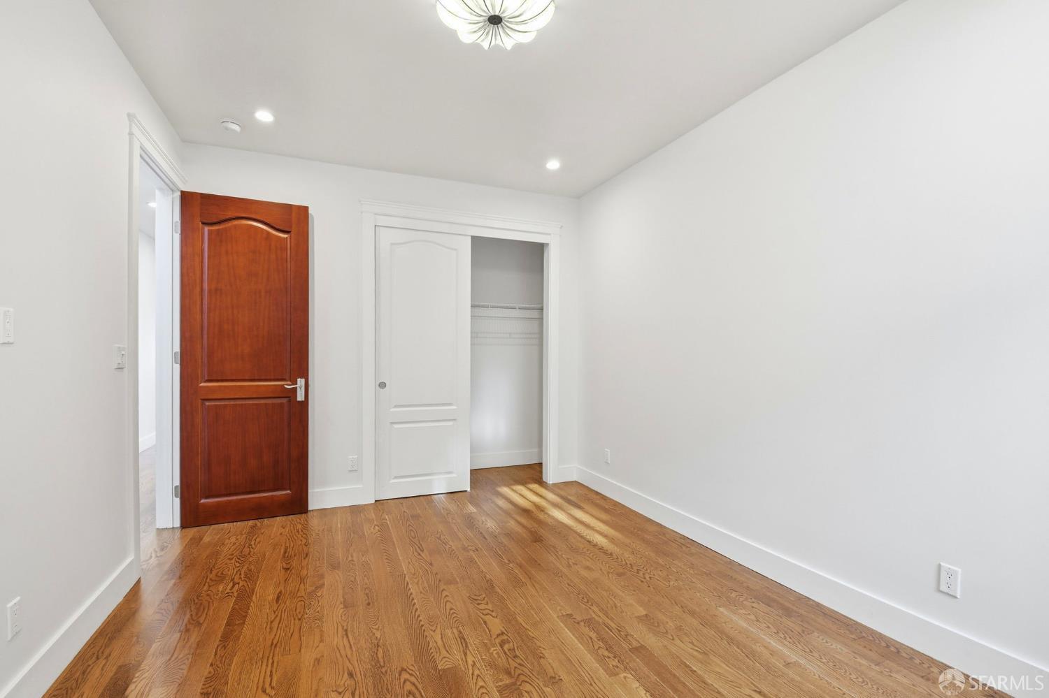 526 Silver Avenue San Francisco, CA 94112 - Photo 26 of 44 a view of empty room with wooden floor