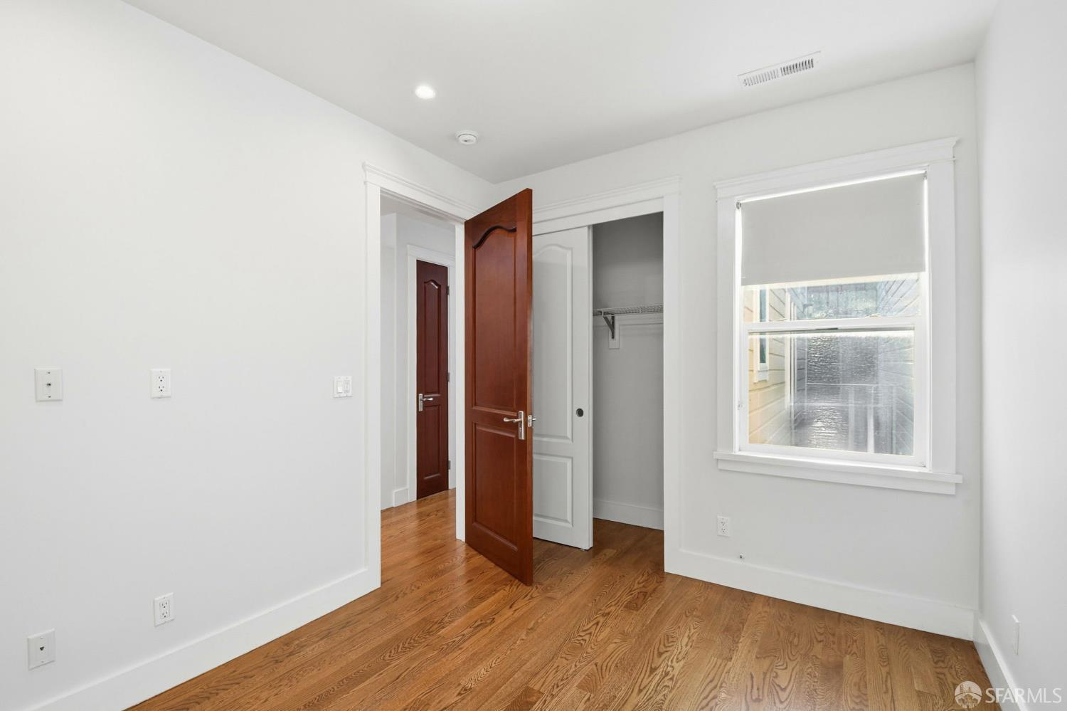 526 Silver Avenue San Francisco, CA 94112 - Photo 27 of 44 an empty room with wooden floor and windows
