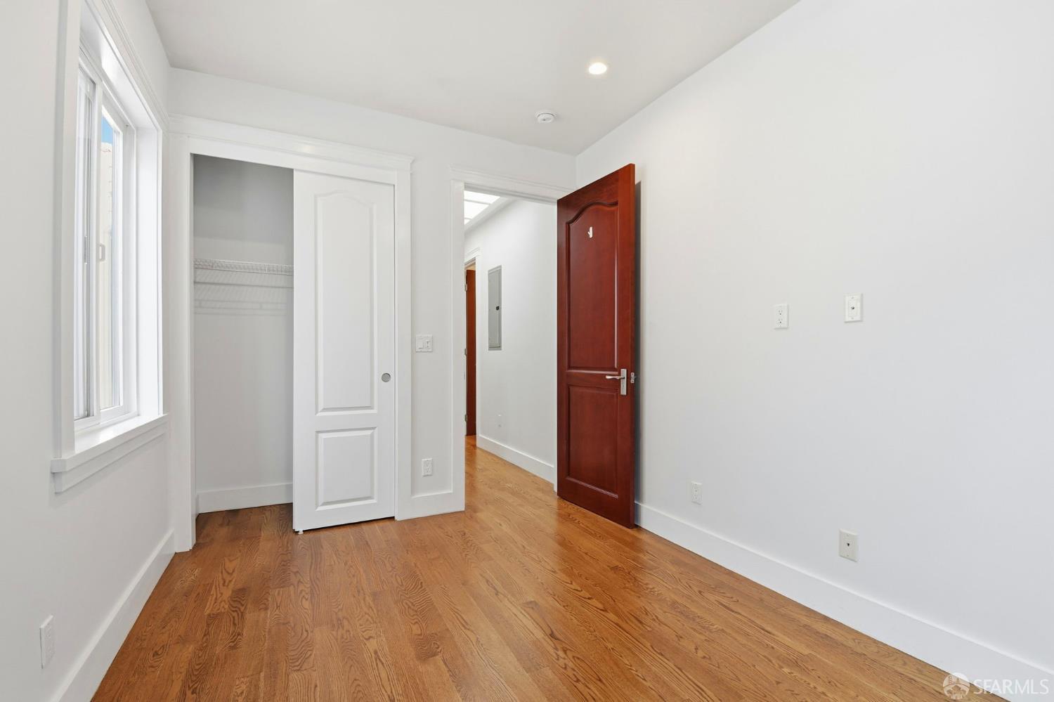 526 Silver Avenue San Francisco, CA 94112 - Photo 29 of 44 an empty room with wooden floor and windows