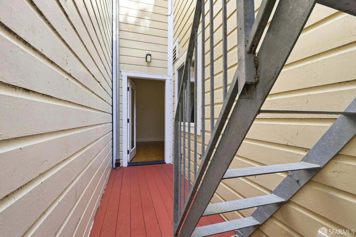 526 Silver Avenue San Francisco, CA 94112 - Photo 44 of 44 a view of staircase with wooden floor and metal railing