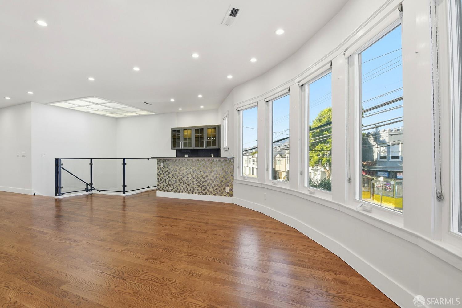 526 Silver Avenue San Francisco, CA 94112 - Photo 8 of 44 a view of an empty room with a window and wooden floor
