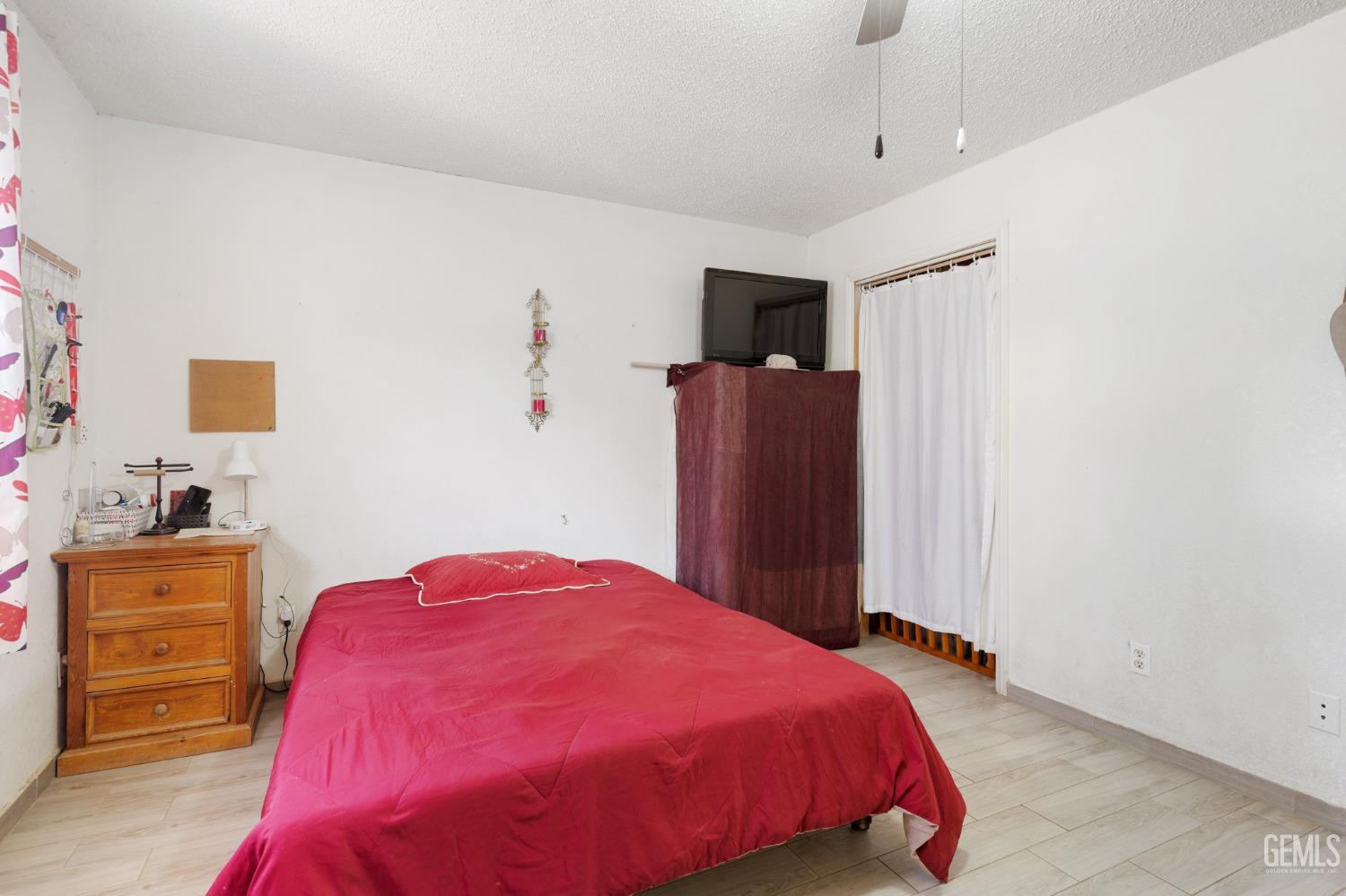 Undisclosed Address Arvin, CA 93203 - Photo 12 of 19 a bedroom with a bed and a closet