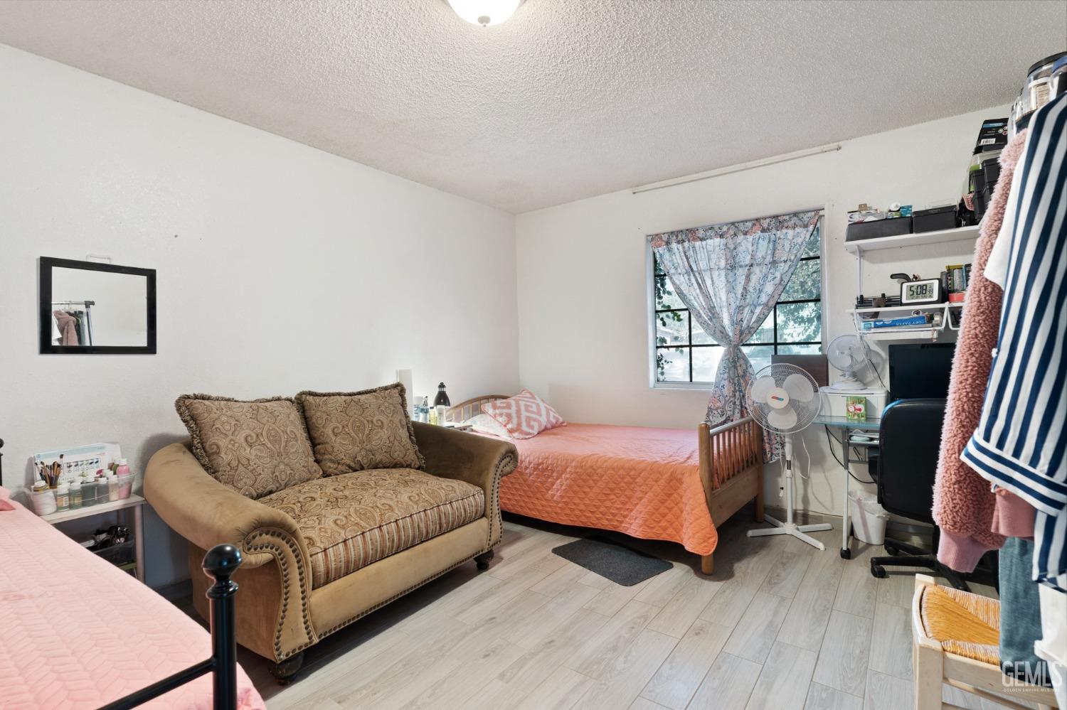 Undisclosed Address Arvin, CA 93203 - Photo 13 of 19 a living room with a bed and a couch