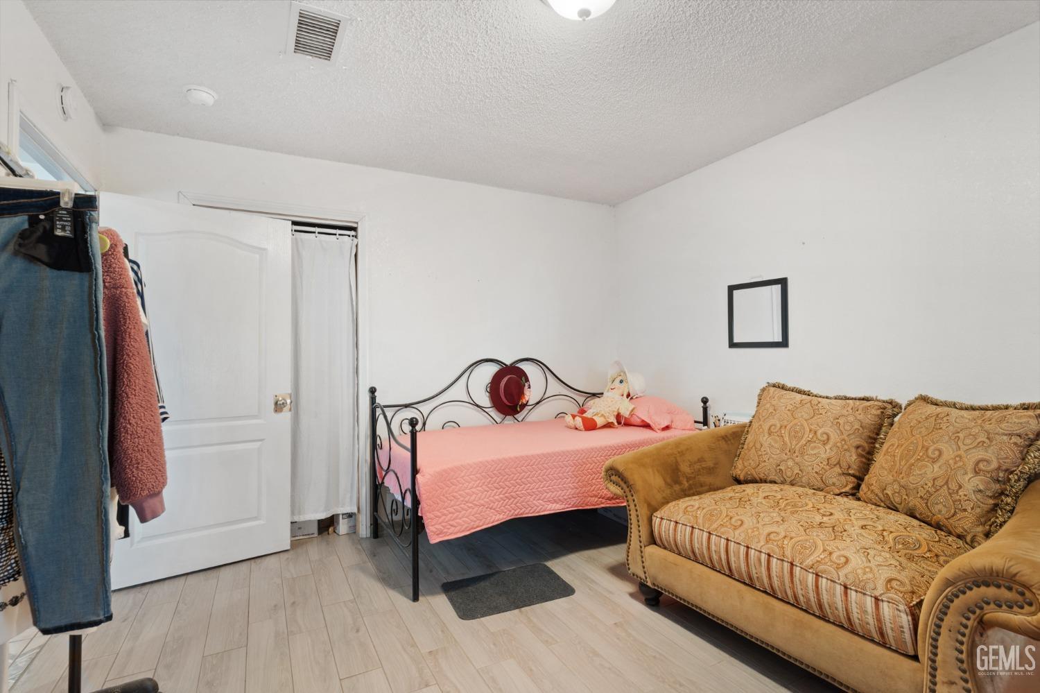 Undisclosed Address Arvin, CA 93203 - Photo 14 of 19 a bedroom with furniture and a wooden floor