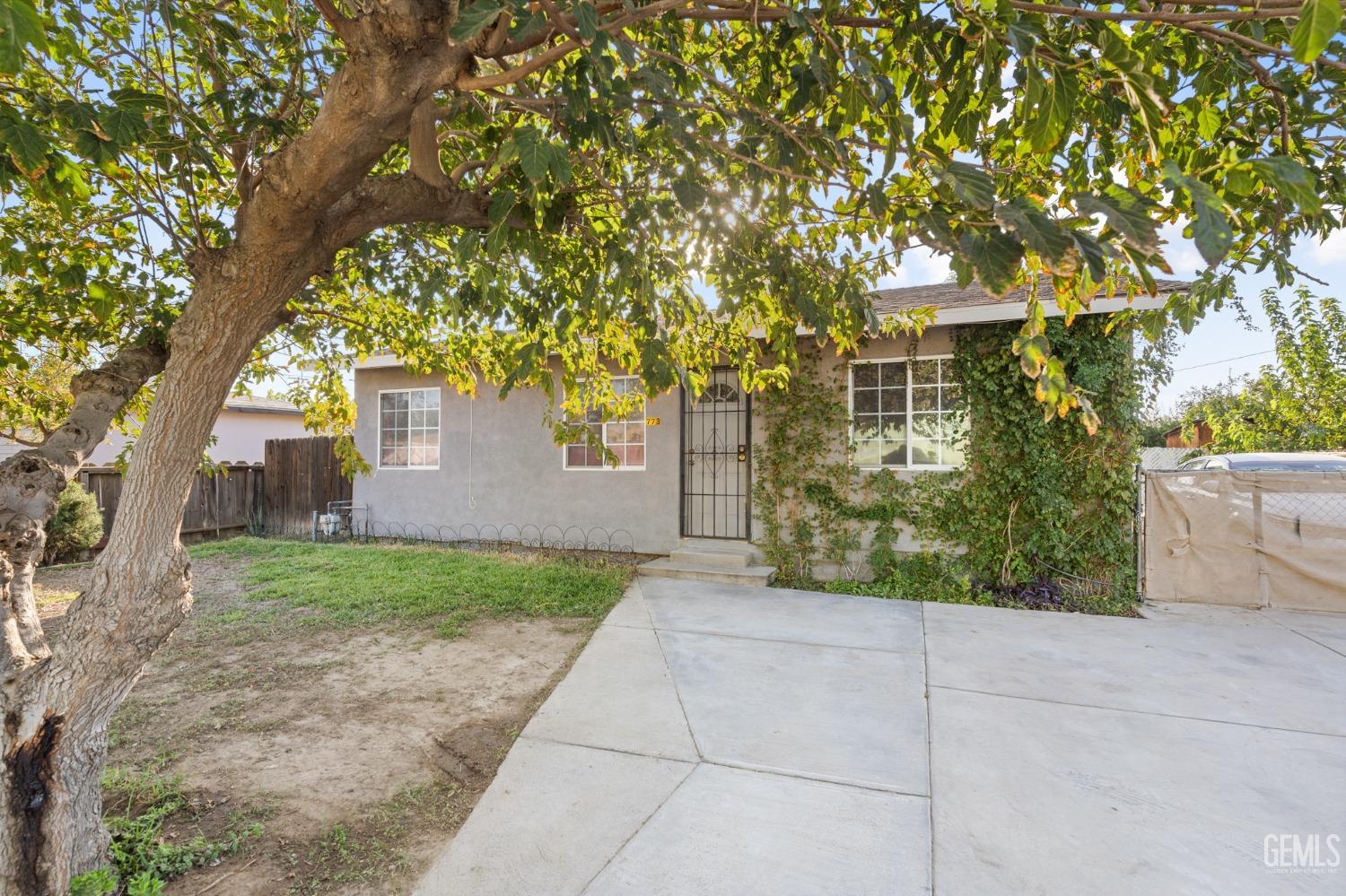 Undisclosed Address Arvin, CA 93203 - Photo 2 of 19 a front view of a house with garden