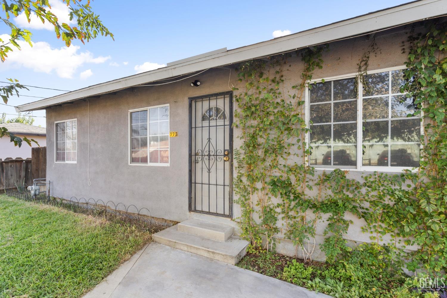Undisclosed Address Arvin, CA 93203 - Photo 3 of 19 a front view of a house with a yard