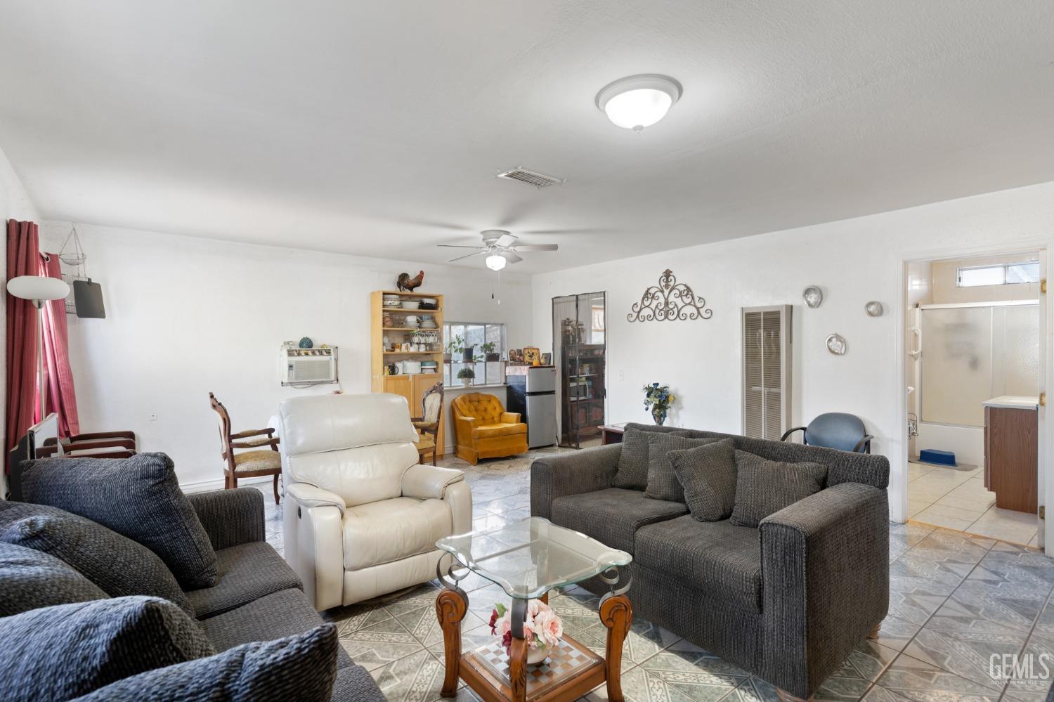 Undisclosed Address Arvin, CA 93203 - Photo 4 of 19 a living room with furniture and a view of kitchen