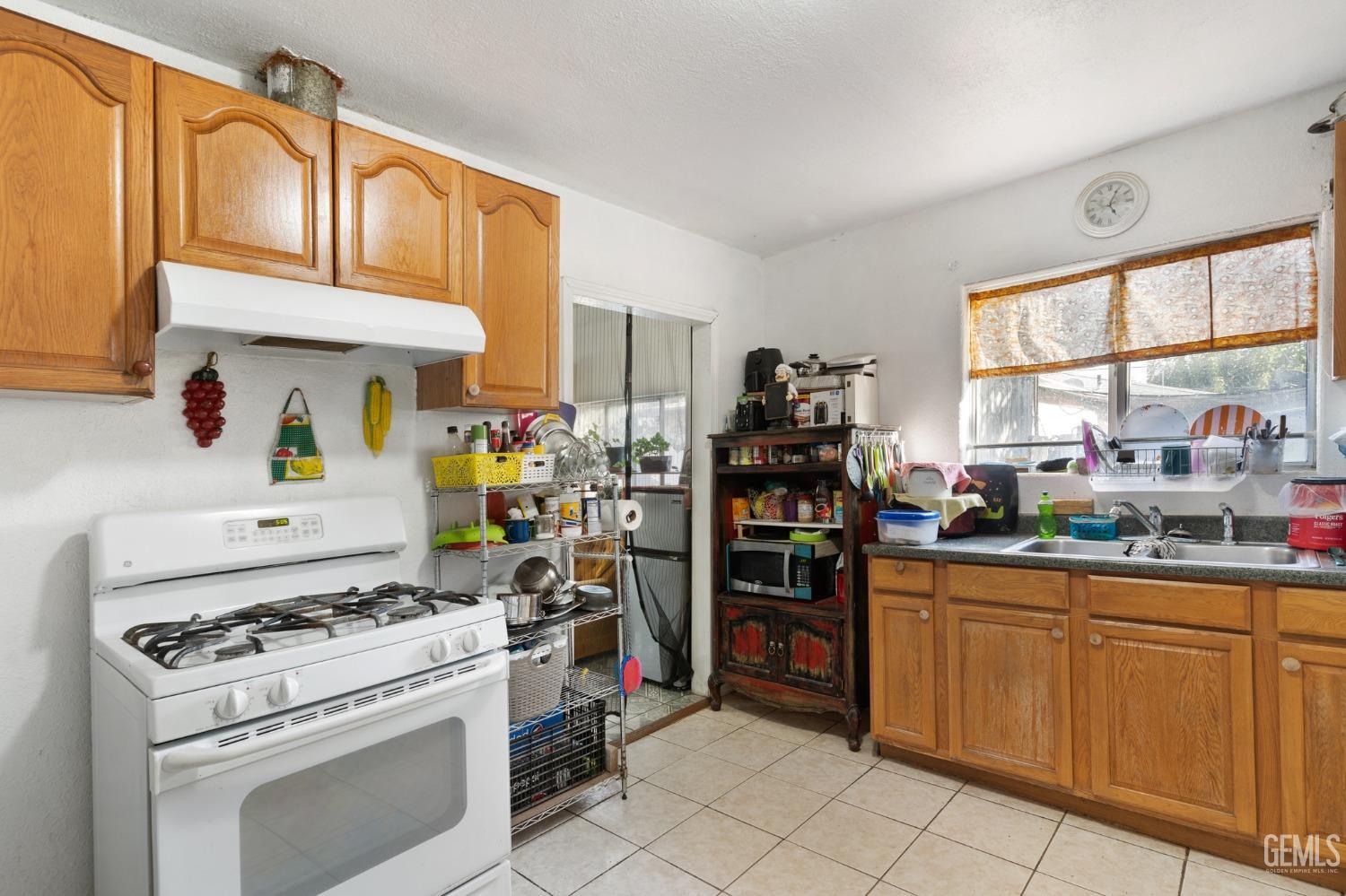 Undisclosed Address Arvin, CA 93203 - Photo 9 of 19 a kitchen with stainless steel appliances granite countertop a stove and a refrigerator