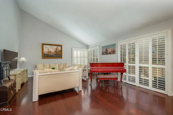 a room with a table chairs and a flat screen tv
